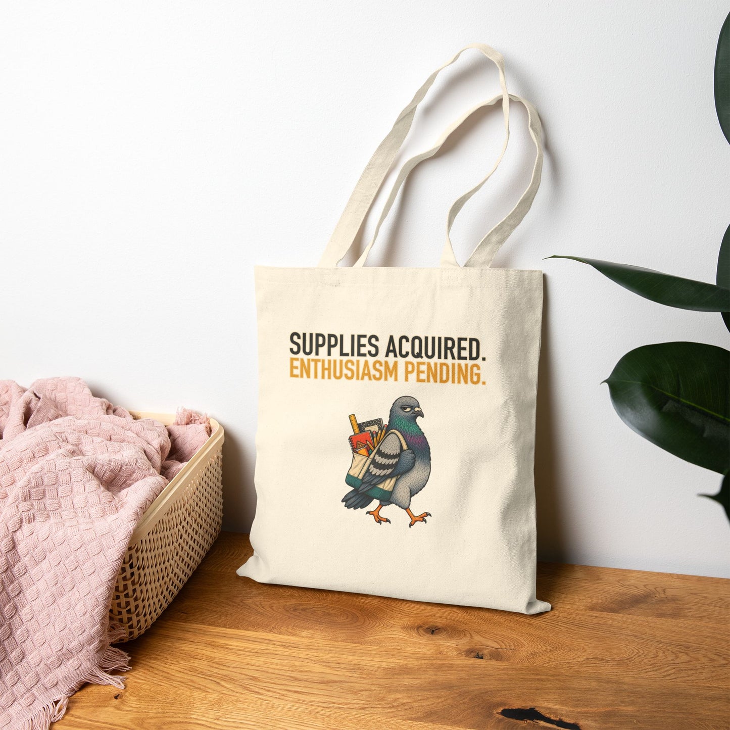 Supplies Acquired Petty Pigeon Tote, natural canvas tote held by the handles