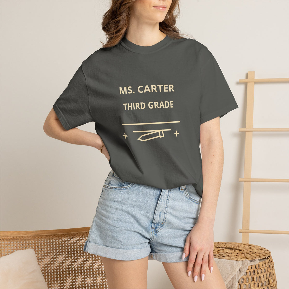 Pepper model wearing the corrected personalized teacher shirt with the name, grade, and school graphic grouped on the upper chest